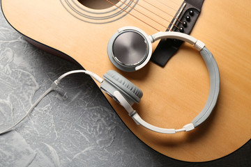 Canvas Print - Classical guitar and headphones on grey background