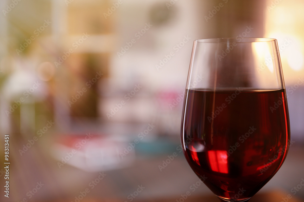 Glass of red wine on blurred background