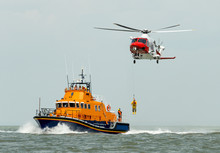 Orange Sea Rescue Boat With Rescue Helicopter