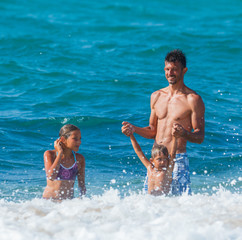 Sticker - Father and children playing in the sea