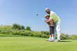 © Jasmin Merdan - Father teaching son playing golf at club
