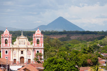 Big Pink Church Standing In Front Of A Mountain Volcano And Trees,  Leon