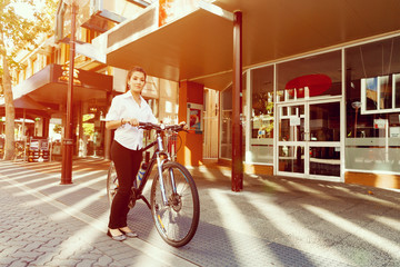 Wall Mural - Portrait of happy young female bicyclist