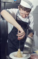 Wall Mural - chef preparing food in the kitchen at the restaurant