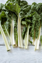 fresh swiss chard on white boards