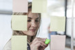 © Westend61 - Woman in office writing on sticky notes