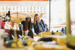 © Westend61 - Two young women at a stall on flea market