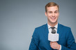  Smiling newsman holding a microphone. 