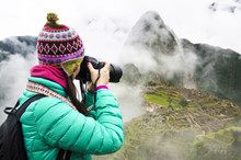 Peru, Machu Picchu Region, Travelling Woman Taking Picture Of Machu Picchu Citadel