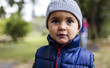 © Westend61 - Portrait of little boy wearing woolly hat and waistcoat