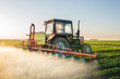 Tractor spraying soybean