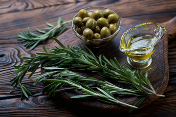 Wall Mural - Close-up of fresh rosemary, olives and pialat with olive oil