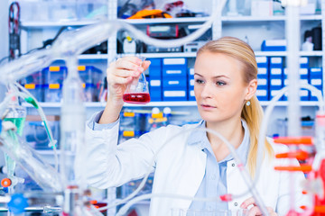 Wall Mural - Chemical laboratory scene: attractive young student scientist ob