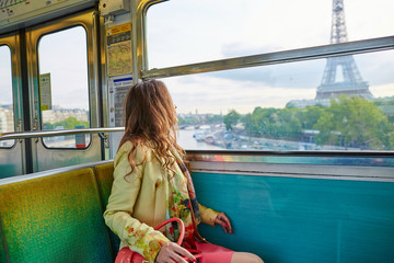 Poster - Beautiful young woman travelling in a train of Parisian underground