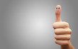 Happy cheerful smiley finger on grey background
