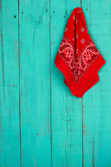 Wall Mural - Red bandanna hanging on rustic teal blue background