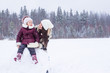 © travnikovstudio - Little girl ang happy mother enjoy winter snowy day
