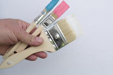 paint brushes stained blue, pink and white