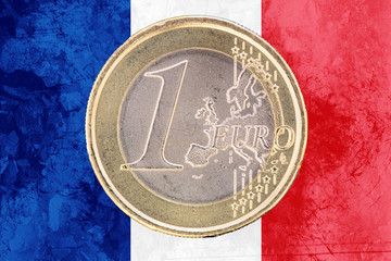 One euro coin on the flag of France as background