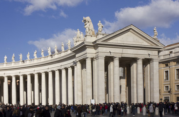 People in Saint Peter Square in Rome, with its monumental colonnade