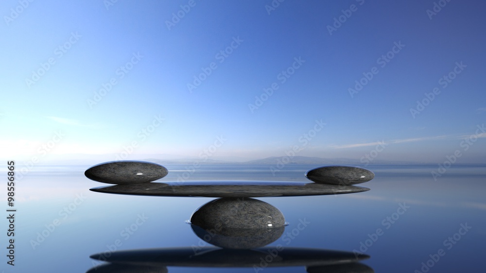 Balancing Zen stones in water with blue sky and peaceful landscape. - obrazy, fototapety, plakaty 