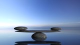 Fototapeta Łazienka - Balancing Zen stones in water with blue sky and peaceful landscape.