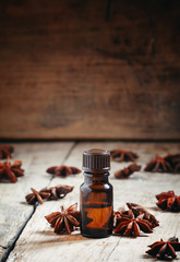 Wall Mural - Essential oil of anise in a small brown bottle, selective focus