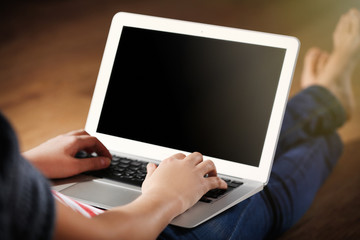 Canvas Print - Woman sitting on the floor and working with a laptop