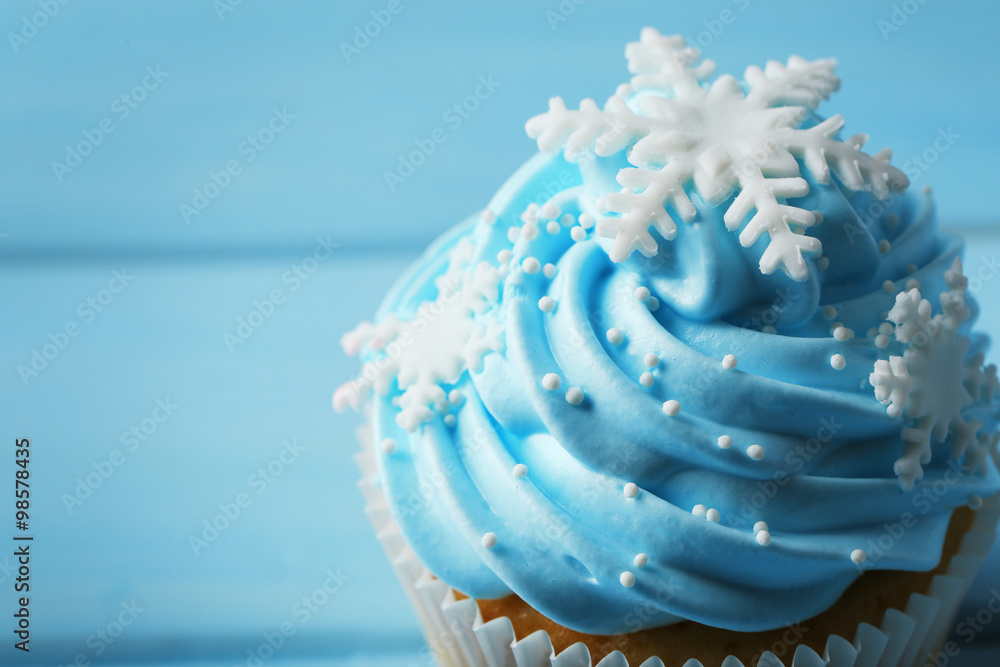 Blue cupcake on wooden background