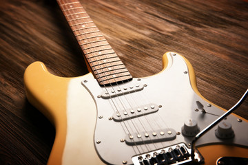 Wall Mural - Electric guitar on wooden background, close up