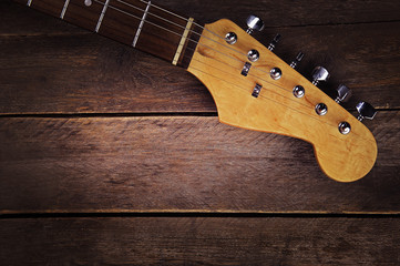 Canvas Print - Electric guitars neck on wooden background, close up