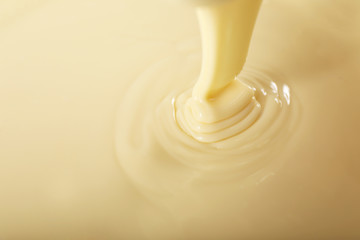 background of condensed milk in a bowl, close-up