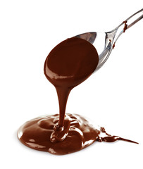 Wall Mural - Melted milky brown chocolate pouring from a spoon, isolated on white