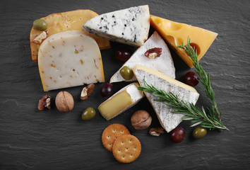 Wall Mural - Composition of fresh cheese, fruits and vegetables on black background, close up