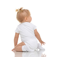 Wall Mural - Infant child baby toddler sitting backwards back wiev and lookin