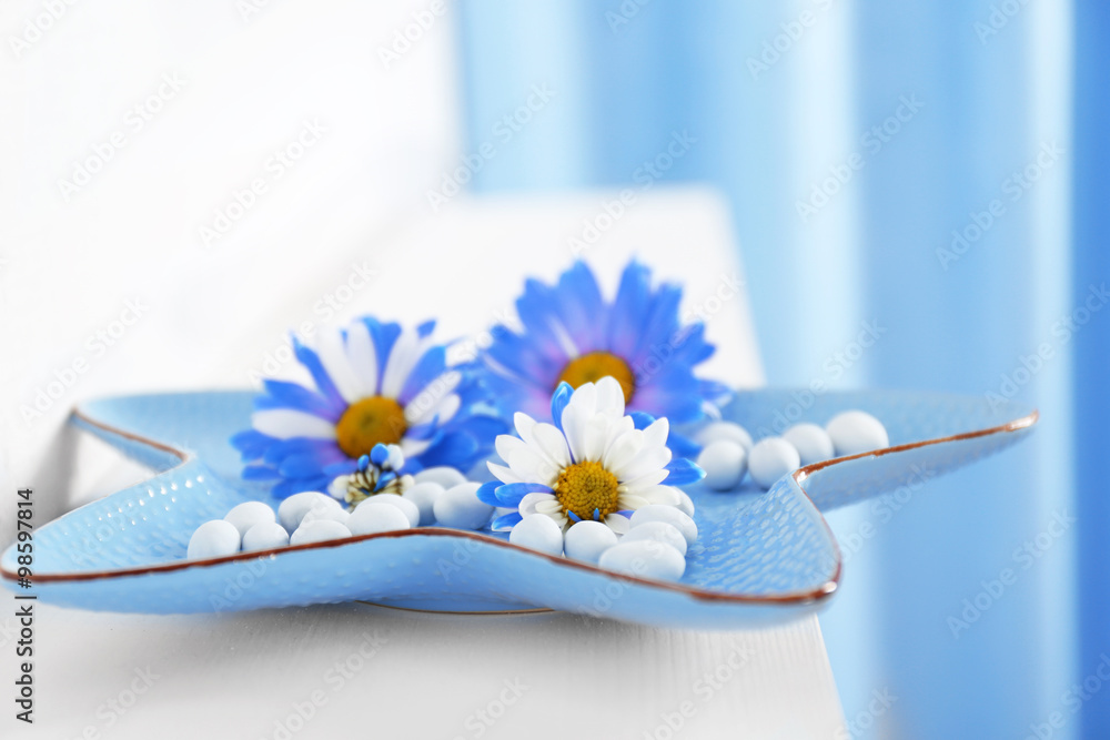 Flowers and sweets on a plate closeup