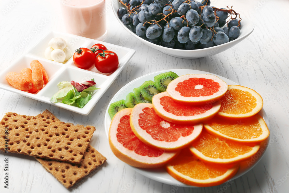 Fruits and vegetables on light wooden background. healthy eating concept.