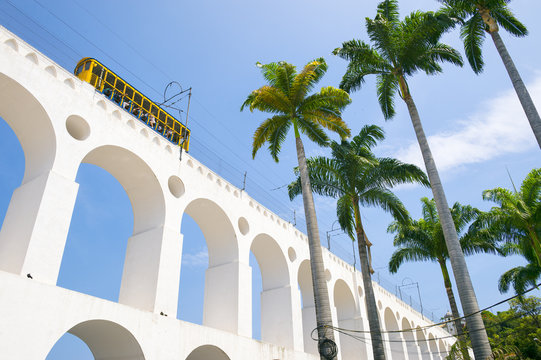 bonde de santa teresa tram train drives along distinctive white arches of the landmark arcos da lapa