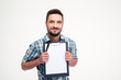 © Drobot Dean - Happy smiling bearded man in checkered shirt holding blank clipboard