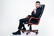 © Drobot Dean - Thoughtful handsome business man in office chair pointing on you