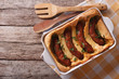 English food: toad in the hole into a baking dish. horizontal top view
