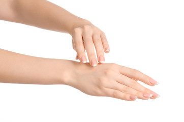 Wall Mural - Health and body care theme: beautiful female hand with white cream isolated on a white background, hand massage