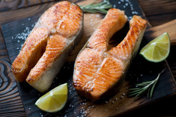 Wall Mural - Two pan fried trout fillets with lime, rosemary and sea salt