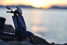 Silhouette Of A Scooter Parked By Sea