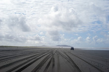 Car Driving On An Empty Sandy Beach