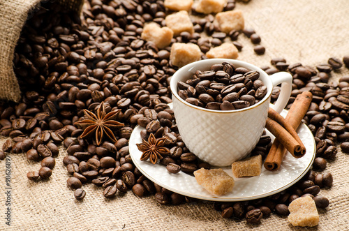 Fotografie, Obraz Coffee beans poured into the Cup and saucer and a bag of coffee