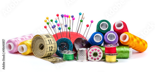 Leinwand Poster  Composition with tailor threads isolated on white background