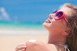 © el.rudakova - Close up of young woman in sunglasses putting sun cream on shoulder