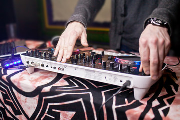 DJ mixing music on console at the night club