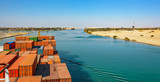 Fototapeta Desenie - Industrial container ship passing through Suez Canal with ship's